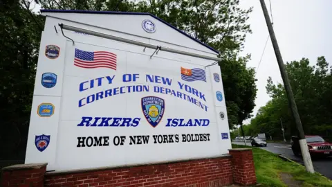 Getty Images A sign outside Rikers Island jail, labelling it "Home of New York's boldest"