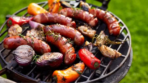 Getty Images Grilled sausages and vegetables on a grilled plate