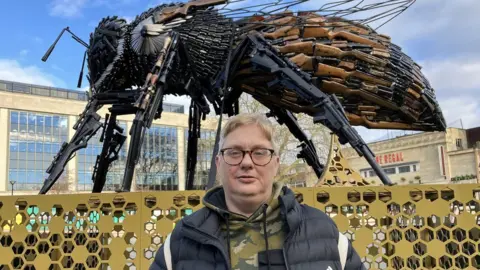 BBC Michelle Polkinghorne stood in front of the bee sculpture