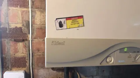 Marsh Family Warning sticker on boiler