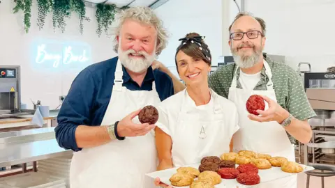 ANNA Cake Couture Anna Tyler holding a tray of cookies pictured with the Hairy Bikers