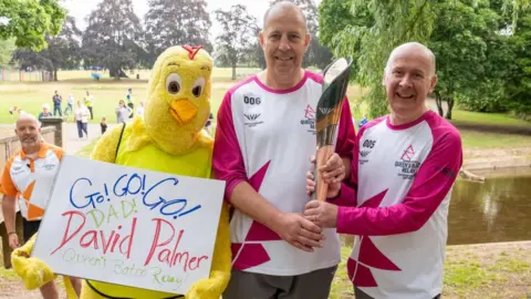 Getty Images David Palmer and Paul Laffey take part in The Queen's Baton Relay as it visits Uttoxeter as part of the Birmingham 2022 Queens Baton Relay on July 20, 2022 in Uttoxeter