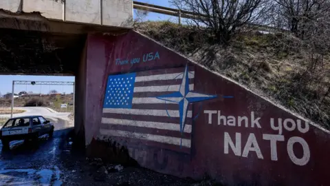Getty Images Graffiti with a US flag saying 'Thank you Nato'