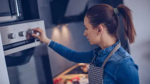 Getty Images Woman cooking in oven