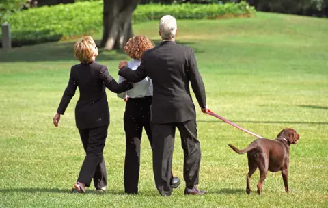 Alamy The Clintons, with daughter Chelsea, take a walk in the White House grounds in 1999