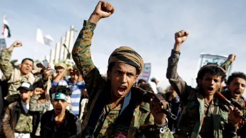 Reuters Houthi supporters shout slogans at a rally to mark the 4th anniversary of the escalation of the war in Yemen (26 March 2019)