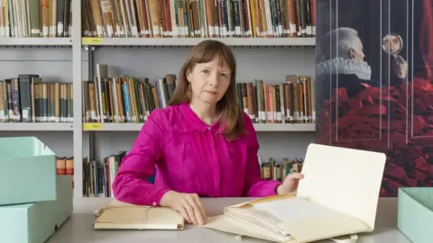 University of Bristol Theatre Collection Keeper holding archived documents