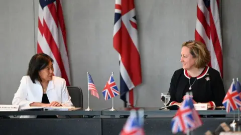 Getty Images United States Trade Representative Katherine Tai (L) and United Kingdom Secretary of State for International Trade Anne-Marie Trevelyan (R) attend a meeting during the second day of the United Kingdom Dialogue on the Future of Atlantic Trade talks in Baltimore, Maryland, on March 22, 2022.