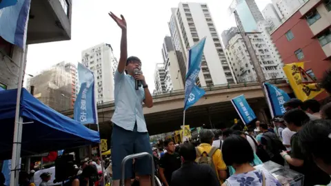 Reuters Pro-democracy activist Joshua Wong wave to supporters during a protest march in Hong Kong, China July 1, 2018, the day marking the 21st anniversary of the city's handover to Chinese sovereignty from British rule.