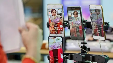 Getty Images A presenter promotes bed linings through a live streaming show in Zhejiang province ahead of Singles' Day on November 10, 2019.