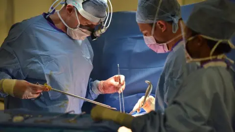 Cancer Research UK Surgeons performing an operation.