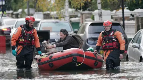 PA Media Stefano Calcagni being rescued by fire crews