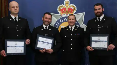 Gwent Police PC Rhydian Jones, PC Gareth Marsh and PC Ashley Cotton receive a commendation for their bravery from Gwent Police chief constable Julian Williams