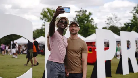 PA Media People take a selfie at UK Black Pride