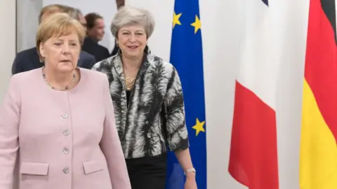 Getty Images Theresa May with Angela Merkel in Japan