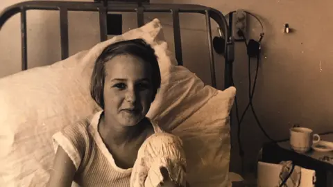 Young Susan Payne in her hospital bed