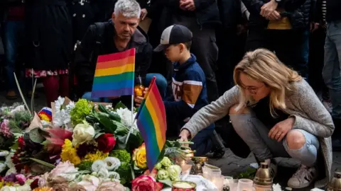 A woman lights a candle