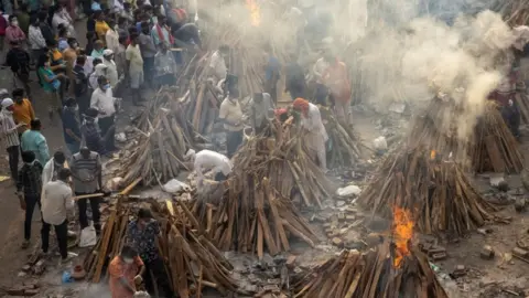 Reuters People cremate their relatives