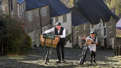 Hovis Carl Barlow and Alex Freeman push their bikes up the hill