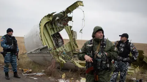 AFP MH17 debris and pro-Russian militia standing guard, 11 Nov 14