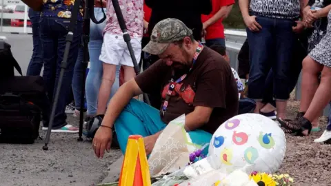 A man cries during a vigil