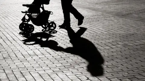 Getty Images Parent pushing pram