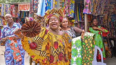 AFP Madame Aboga, a stall keeper at the Ngobila Beach market in Kinshasa, DR Congo - Thursday 9 June 2022