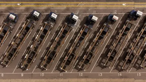 PA Media Shipping container transporters sit in the Port of Felixstowe in Suffolk, following a strike by members of the Unite union at Britain's biggest and busiest container port