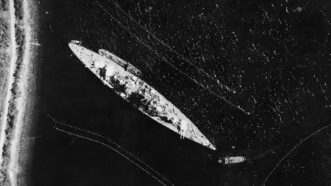 IWM/Getty Images Royal Air Force: Operations By The Photographic Reconnaissance Units, 1939-1945, Vertical photographic-reconnaissance aerial of the German battleship TIRPITZ moored in Narvik-Bogen Fjord, Norway, 17 July 1942. (Photo by No. 1 PRU/ Imperial War Museums via Getty Images)