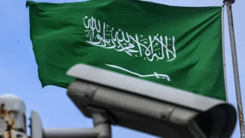 AFP A Saudi flag flutters near a security camera on top of the Saudi consulate in Istanbul. 11 October 2018