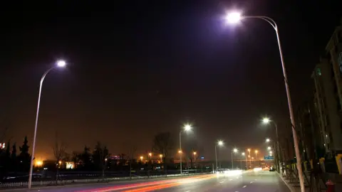 Getty Images Traffic passes along a street in lit up by LED lights that are in a testing phase in Tianjin, China