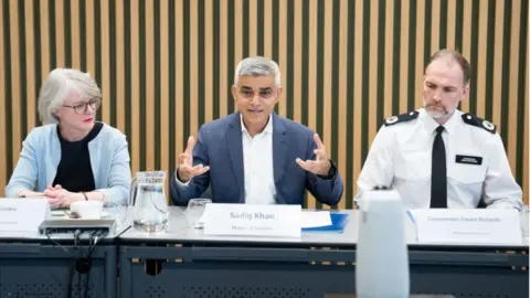 PA Media Sadiq Khan and Met officers at table