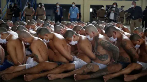 Reuters Gang members wait outside their cells during a search at the Izalco jail during a media tour, in Izalco, El Salvador September 4, 2020.