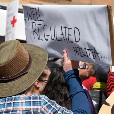 Getty Images A gun control advocate holds a handmade sign with quoting a portion of the U.S. Constitution's Second Amendment at a 'March For Our Lives' rally in Santa Fe, New Mexico