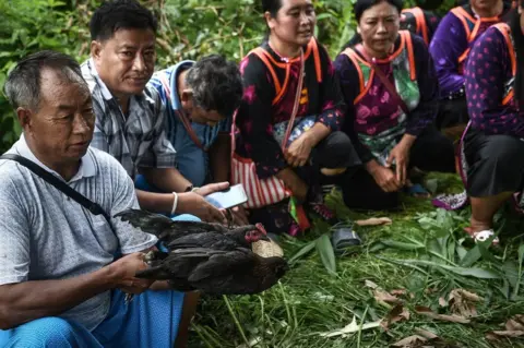 Getty Images Ethnic Lisu tribespeople hold a ritual in Khun Nam Nang Non Forest Park