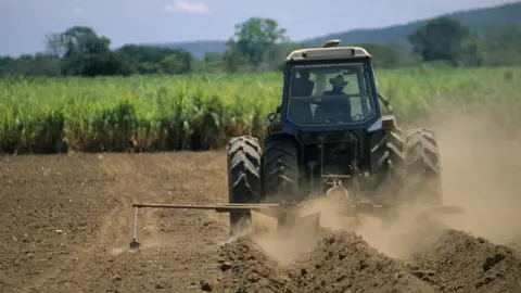 Getty Images A farmer ploughing a field in the US