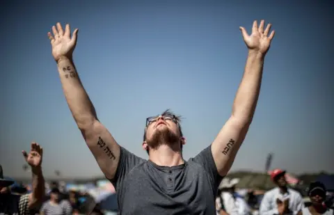 AFP Followers of South African Christian revival evangelist Angus Buchan pray at an informal airfield outside Pretoria on October 27, 2018, for the 'It's Time' prayer, an event poised to become the Southern Africa's biggest ever prayer meeting...