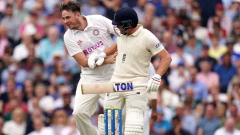 PA Media A man collides with England batsman Jonny Bairstow