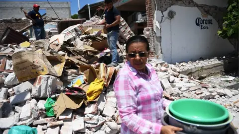 AFP/GETTY People search rubble for their belongings in clean-up operation