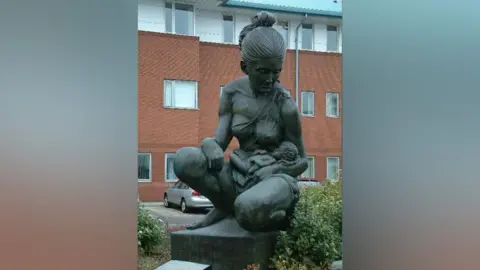 Peter Hodge/Geograph A statue of a mother holding a baby outside Liverpool Women's Hospital