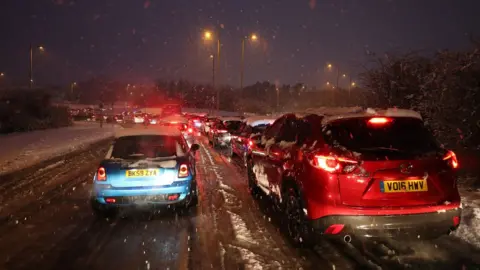 Andrew Matthews/PA Wire Cars stuck in traffic on Ringway West in Basingstoke due to snowfall in the area on Friday 1 February