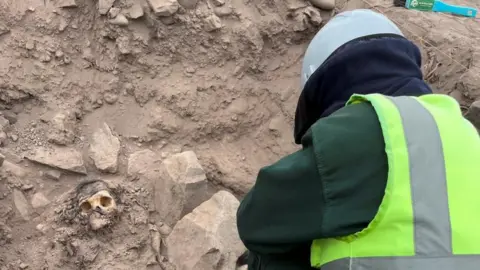 Reuters An archaeologist works at the excavation site of a pre-Hispanic burial next to a mummy believed to be from the Manchay culture, which developed in the valleys of Lima between 1,500 and 1,000 BCE, in Lima, Peru, June 14, 2023.