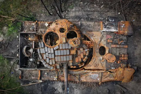 Christopher Furlong / Getty Images A destroyed Russian tank begins to rust in woodland near Kyiv, Ukraine, on 7 June 2022