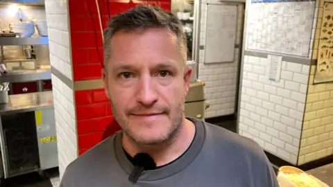 BBC Photo of Toby Gritten facing the camera in the kitchen of The Pump House