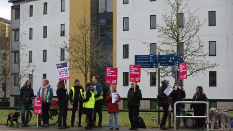 Getty Images Workers on the picket line on the University of East Anglia (UEA) main campus on 30 November 2022 in Norwich