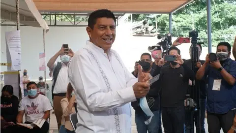 EPA Salomon Jara, candidate for Morena, waves after voting in Oaxaca, Mexico, 05 June 2022.