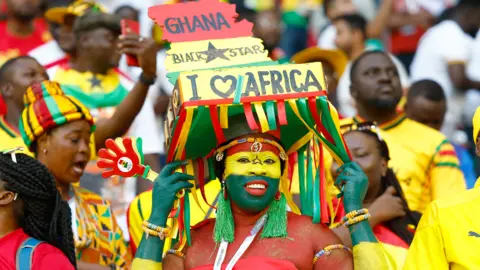 Getty Images Black Stars fans in Qatar dressed up in the stadium for the match against South Korea on 28 November 2022