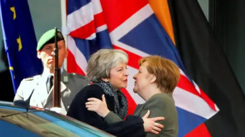 Hannibal Hanschke/Reuters German Chancellor Angela Merkel kisses British Prime Minister Theresa May