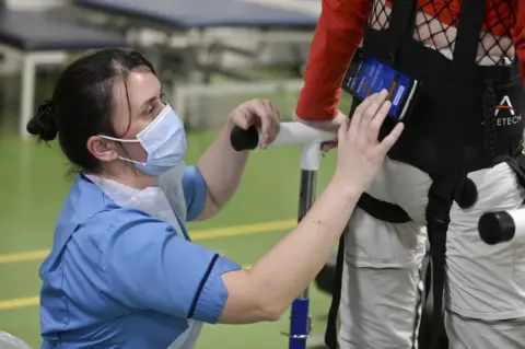 PA Media Physiotherapist Claire Lincoln with patient Luke Louden on the ZeroG Gait and Balance System