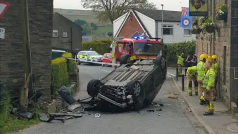 Lancashire Police Car flipped on to its roof on Tong End in Whitworth